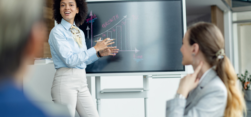 Black Female Entrepreneur Presenting Business Growth Chart Meeting Office